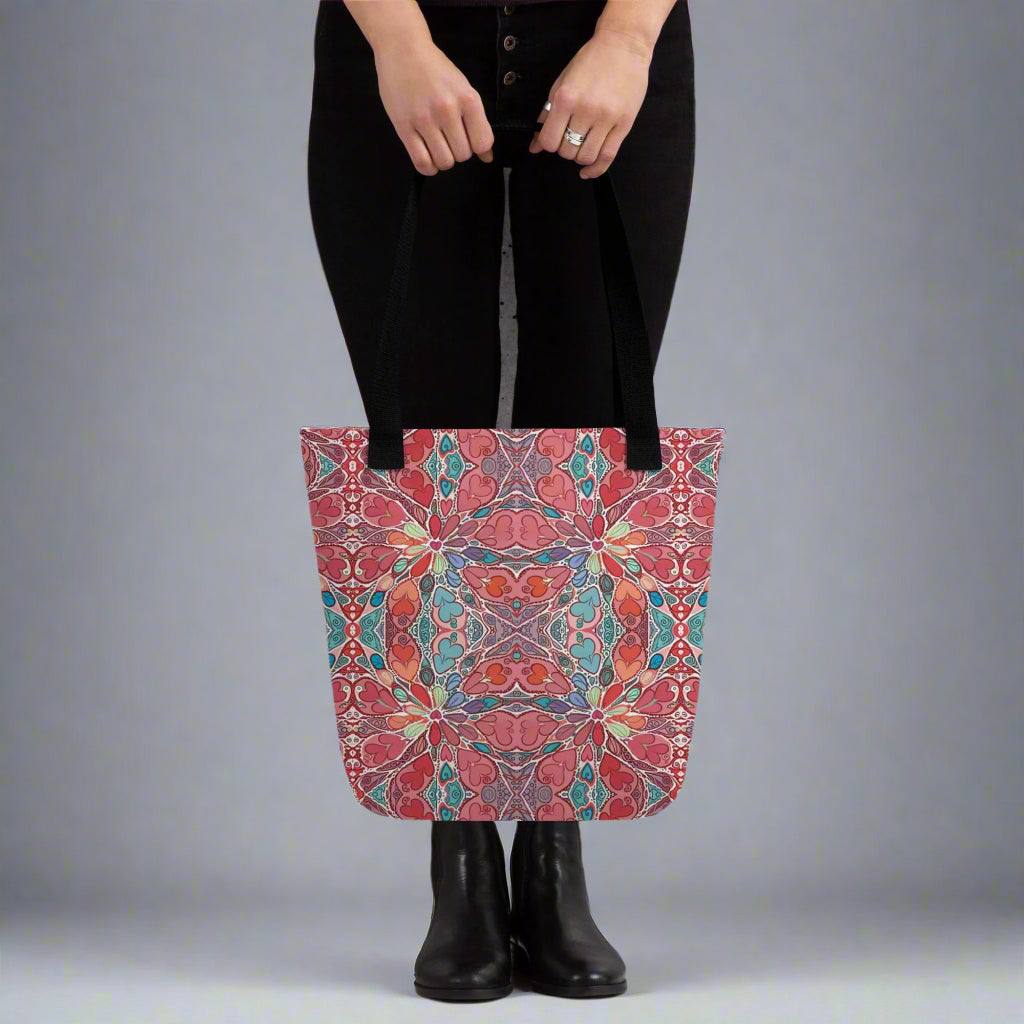 Boho Mandala Tote Bag with colorful heart-inspired art print being held, stylish and reusable for shopping or daily use.