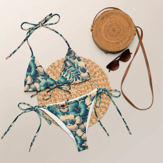 Elegant Tropical Blue Floral String Bikini Set with UPF 50+, showcasing deep teal and gold floral print, adjustable halter ties, and side-tie bottoms.