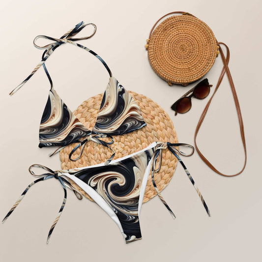 Elegant marble swirl string bikini set with UPF 50+ in black, gold, and beige, displayed with accessories.