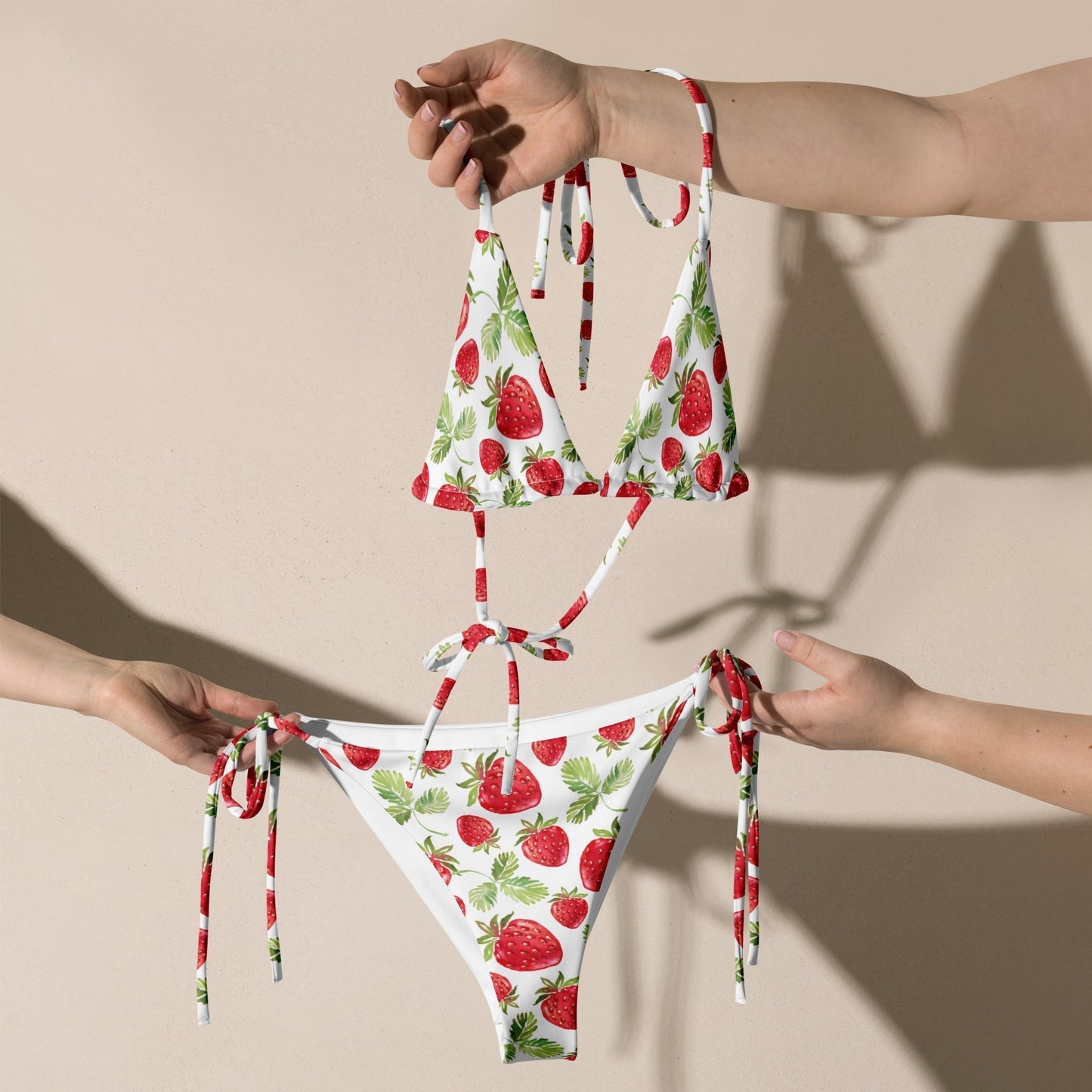 Strawberry pattern recycled string bikini with adjustable straps and removable padding.