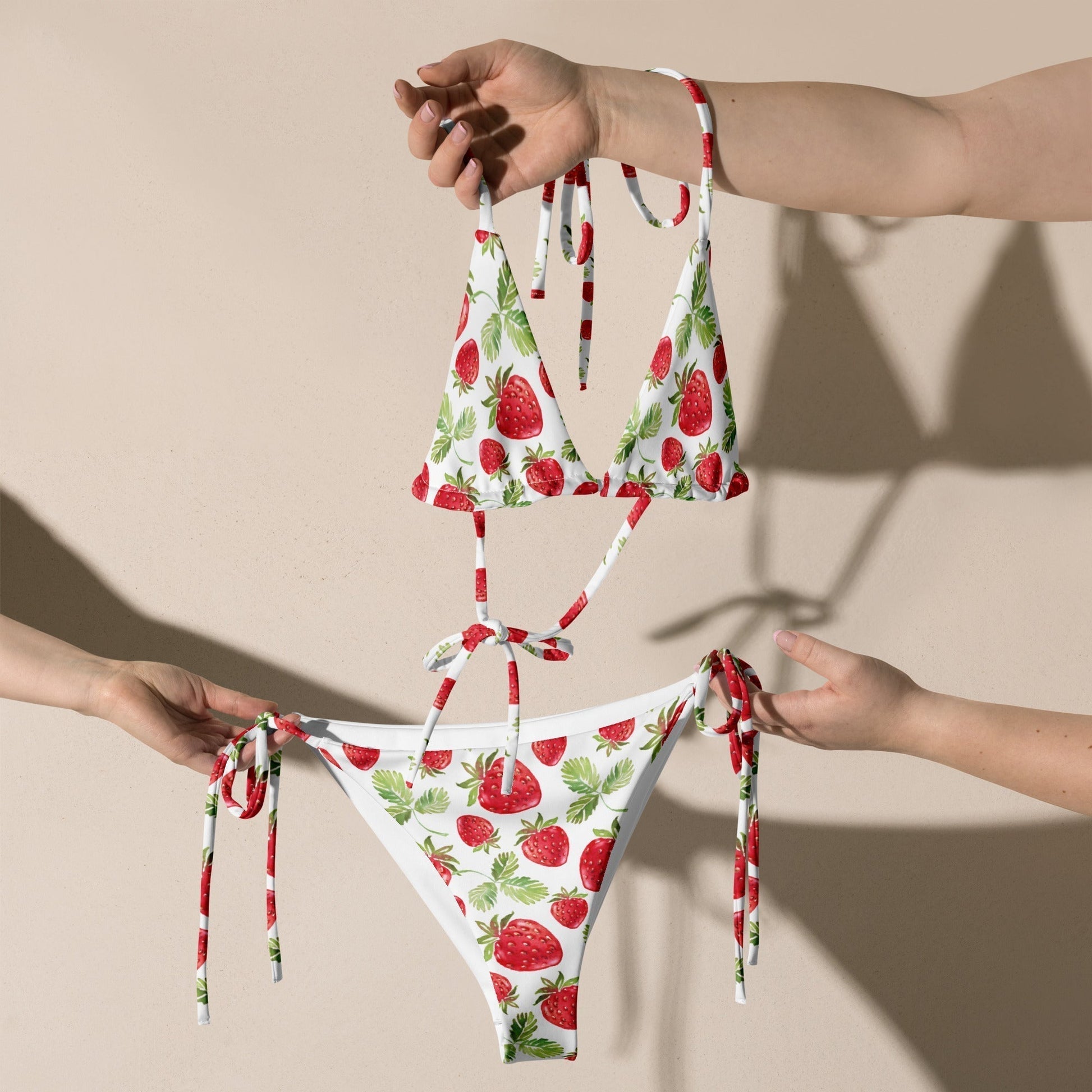 Strawberry pattern recycled string bikini with adjustable straps and removable padding.