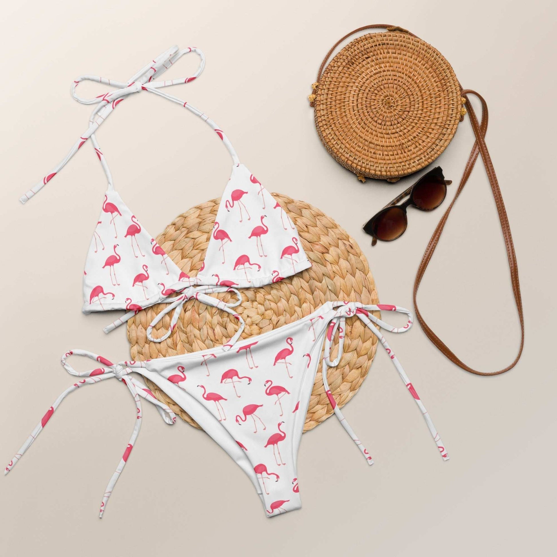 Flamingo print halter bikini set with keyhole halter top and adjustable ties on a white background.