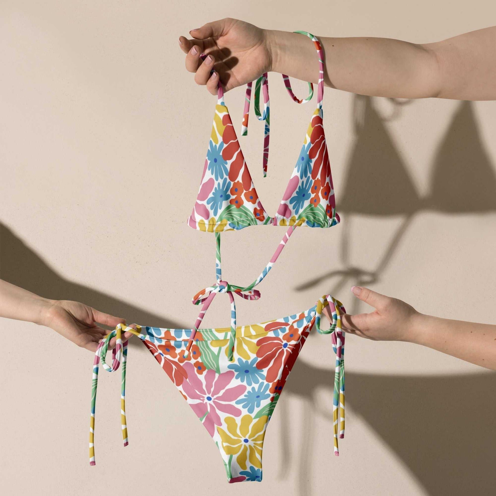 Vibrant Tropical Floral String Bikini Set with UPF 50+, colorful two-piece swimsuit, adjustable ties, inclusive sizing.