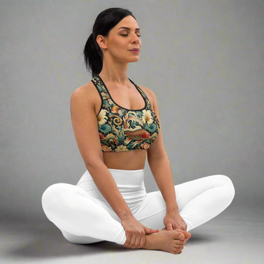 Woman wearing a swimming koi pattern sports bra, seated in a yoga pose, emphasizing moisture-wicking and support for workouts.