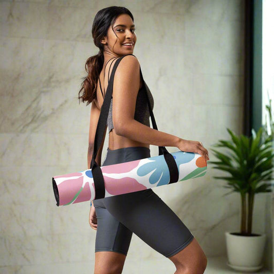 Floral print yoga mat with anti-slip microsuede, rolled up and carried by a woman.