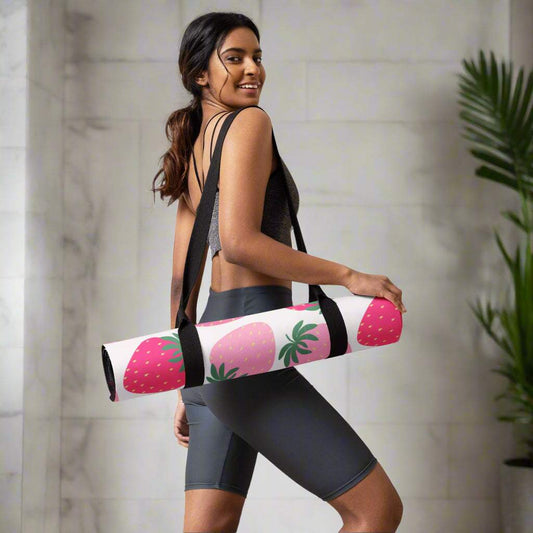Yoga mat with strawberry print, anti-slip design, carried by a woman in workout gear.